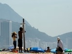  Bathers cool off in a shower on Copacabana Beach during a heatwave in Rio de Janeiro, Brazil, in November. (CREDIT: AFP)