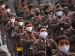 School students wear face masks during prayer amid rise in Covid-19 cases in the country, in Jammu on Friday
