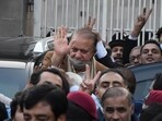 Pakistan's former Prime Minister Nawaz Sharif, center in brown coat, waves to his supporters as he leaves after a court hearing in Islamabad, Pakistan, Tuesday, Dec. 12, 2023.