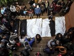 People stand over the shrouded bodies of loved ones killed during Israeli bombardment at Nasser Hospital in Khan Yunis on the southern Gaza Strip People stand over the shrouded bodies of loved ones killed during Israeli bombardment at Nasser Hospital in Khan Yunis on the southern Gaza Strip