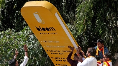 Karnataka Rakshana Vedike (KRV) members vandalize an advertising board of a business establishment during a protest to minimalise the usage of English and promote the native language in banners and signboards, in Bengaluru on Wednesday. (Savitha) Karnataka Rakshana Vedike (KRV) members vandalize an advertising board of a business establishment during a protest to minimalise the usage of English and promote the native language in banners and signboards, in Bengaluru on Wednesday. (Savitha)