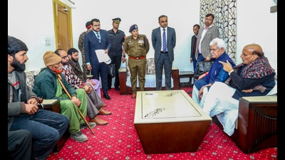 Defence Minister Rajnath Singh accompanied by Jammu and Kashmir Lieutenant Governor Manoj Sinha meets the families of the three civilians who were killed near the site of an anti-terrorist operation in Poonch, during his visit to Rajouri on Wednesday. (ANI)