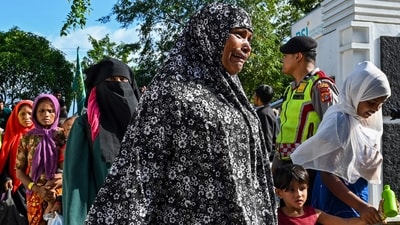 Rohingya refugees enter the compounds of a government building after demonstrating university students forced them to relocate from a previous government facility, in Banda Aceh. (AFP) Rohingya refugees enter the compounds of a government building after demonstrating university students forced them to relocate from a previous government facility, in Banda Aceh. (AFP)