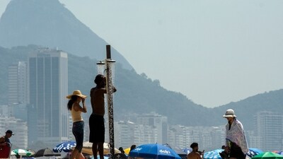 Bathers cool off in a shower on Copacabana Beach during a heatwave in Rio de Janeiro, Brazil, in November. (CREDIT: AFP) Bathers cool off in a shower on Copacabana Beach during a heatwave in Rio de Janeiro, Brazil, in November. (CREDIT: AFP)
