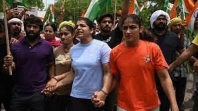 Indian wrestlers Bajrang Punia, Sakshi Malik, and Vinesh during a protest (HT_PRINT) Indian wrestlers Bajrang Punia, Sakshi Malik, and Vinesh during a protest (HT_PRINT)