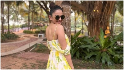 Rakul accessorised the dress minimally with aqua blue embellished slip-on sandals, rings, gold earrings, and retro-style tinted sunglasses. Lastly, she chose a pulled-back top knot, glossy nude lip shade, rouge on the cheekbones, beaming highlighter, and feathered brows for the glam picks. (Instagram) Rakul accessorised the dress minimally with aqua blue embellished slip-on sandals, rings, gold earrings, and retro-style tinted sunglasses. Lastly, she chose a pulled-back top knot, glossy nude lip shade, rouge on the cheekbones, beaming highlighter, and feathered brows for the glam picks. (Instagram)