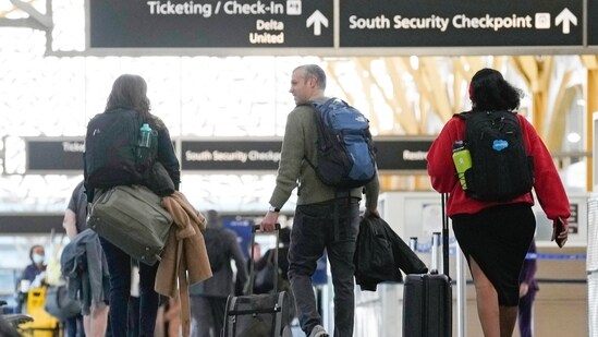 People walk through Reagan Washington National Airport in Arlington. (AP Photo/Susan Walsh) (AP)