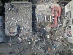 Israel-Hamas War: Palestinians gather at the site of Israeli strikes on houses, amid the ongoing conflict between Israel and Hamas. 