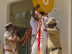 Police personnel try to stop Karnataka Rakshana Vedike (Narayana Gowda faction) activists vandalising a signboard of a business establishment, in Bengaluru, Wednesday. (PTI) Police personnel try to stop Karnataka Rakshana Vedike (Narayana Gowda faction) activists vandalising a signboard of a business establishment, in Bengaluru, Wednesday. (PTI)