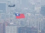 China-Taiwan Conflict: A Chinook helicopter carrying a Taiwan flag flies over the city during the country's National Day celebration in Taipei, Taiwan.