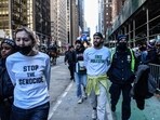 NEW YORK, NEW YORK - NOVEMBER 23: Pro-Palestinian protesters are detained during Macy's annual Thanksgiving Day Parade on November 23, 2023 in New York City. Thousands of people lined the streets to watch the 25 balloons and hundreds of performers march in this parade happening since 1924. 