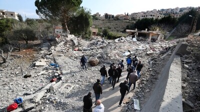 Lebanese citizens gather in front of a house that was destroyed by an Israeli airstrike (AP) Lebanese citizens gather in front of a house that was destroyed by an Israeli airstrike (AP)