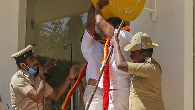Police personnel try to stop Karnataka Rakshana Vedike (Narayana Gowda faction) activists vandalising a signboard of a business establishment, in Bengaluru, Wednesday. (PTI) Police personnel try to stop Karnataka Rakshana Vedike (Narayana Gowda faction) activists vandalising a signboard of a business establishment, in Bengaluru, Wednesday. (PTI)