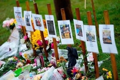 Rain soaked memorials for those who died sit along the roadside by Schemengees Bar & Grille, Monday, Oct. 30, 2023, in Lewiston, Maine (AP Photo/Matt York, File) (AP) Rain soaked memorials for those who died sit along the roadside by Schemengees Bar & Grille, Monday, Oct. 30, 2023, in Lewiston, Maine (AP Photo/Matt York, File) (AP)