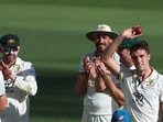 Australia's Pat Cummins, right, hold up the ball after taking 5 wickets against Pakistan during Day 4. Australia's Pat Cummins, right, hold up the ball after taking 5 wickets against Pakistan during Day 4.