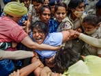 Security personnel detain wrestler Sakshi Malik during wrestlers' protest