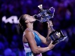 Belarus’ Aryna Sabalenka celebrates with the trophy after winning her final match against Kazakhstan’s Elena Rybakina
