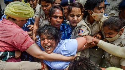 Security personnel detain wrestler Sakshi Malik during wrestlers' protest (PTI) Security personnel detain wrestler Sakshi Malik during wrestlers' protest (PTI)