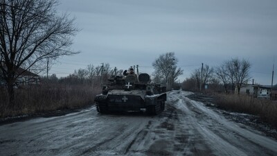 A Ukrainian serviceman rides in an armoured vehicle along a road near a front line, amid Russia's attack on Ukraine, in the Kharkiv region, (REUTERS)
