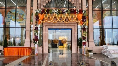 An entrance to the newly constructed airport in Ayodhya is decorated with flowers ahead of its inauguration on Saturday. The airport, positioned approximately 15 km from Ayodhya's main city, incorporates modern construction materials in its core. However, the terminal's exterior, akin to the design of the new Ayodhya station building, embraces a traditional aesthetic. Even the primary gateway follows a similar construction approach, featuring a concrete core adorned with sandstone cladding that showcases stylized carvings. (ANI)