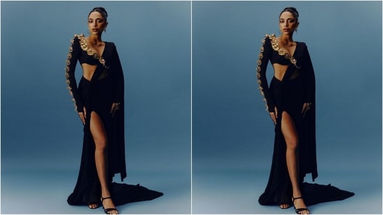 In one of her looks, Sobhita wore a reimagined black saree featuring a bralette-style blouse with a deep plunging neckline and full sleeves adorned with intricate gold embroidered embellishments. She draped it around her in an interesting way, letting the pallu fall beautifully from her shoulders. The thigh high slit at the bottom added to the glam factor.(Instagram/@sobhitad)