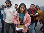 Indian wrestler Vinesh Phogat, a two-time World Championship medal winner, walks with her Arjuna and Khel Ratna Awards