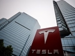 A Tesla logo is seen outside a showroom of the carmaker in Beijing, China.