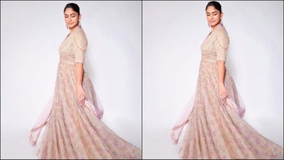 Mrunal's anarkali kurta set features a luxurious georgette and silk fabric, a deep v-neckline, elbow-length sleeves and intricate multi-coloured thread embroidery with crystal detailing at the yoke. The bottom of her kurta featured multicoloured floral prints and a beautiful flared hem. She paired it with a matching duppata and a stretch net churidar. (Instagram/@mrunalthakur) Mrunal's anarkali kurta set features a luxurious georgette and silk fabric, a deep v-neckline, elbow-length sleeves and intricate multi-coloured thread embroidery with crystal detailing at the yoke. The bottom of her kurta featured multicoloured floral prints and a beautiful flared hem. She paired it with a matching duppata and a stretch net churidar. (Instagram/@mrunalthakur)