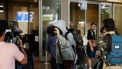 A person, who was on board Nicaragua-bound flight grounded in France on suspicion of human trafficking, evades the media as he leaves the Mumbai airport. (REUTERS) (Representative Image) A person, who was on board Nicaragua-bound flight grounded in France on suspicion of human trafficking, evades the media as he leaves the Mumbai airport. (REUTERS) (Representative Image)