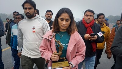 Indian wrestler Vinesh Phogat, a two-time World Championship medal winner, walks with her Arjuna and Khel Ratna Awards (AP) Indian wrestler Vinesh Phogat, a two-time World Championship medal winner, walks with her Arjuna and Khel Ratna Awards (AP)