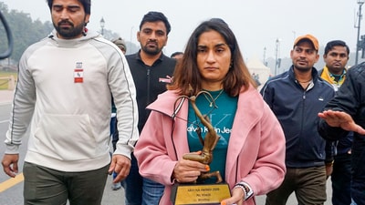 Wrestler Vinesh Phogat walks with her Arjuna and Khel Ratna Awards. She kept the awards at Kartavya Path on Saturday. (PTI) Wrestler Vinesh Phogat walks with her Arjuna and Khel Ratna Awards. She kept the awards at Kartavya Path on Saturday. (PTI)