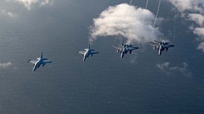 TOPSHOT - In this handout photo taken on November 21, 2023 received through the US embassy in Manila on November 23 shows two Philippine Air Force FA-50s (L) flying alongside two US Air Force F-15C Eagles over the South China Sea during the joint maritime and air patrols. US and Philippine troops began joint maritime and air patrols off the Southeast Asian country on November 21, (AFP) TOPSHOT - In this handout photo taken on November 21, 2023 received through the US embassy in Manila on November 23 shows two Philippine Air Force FA-50s (L) flying alongside two US Air Force F-15C Eagles over the South China Sea during the joint maritime and air patrols. US and Philippine troops began joint maritime and air patrols off the Southeast Asian country on November 21, (AFP)