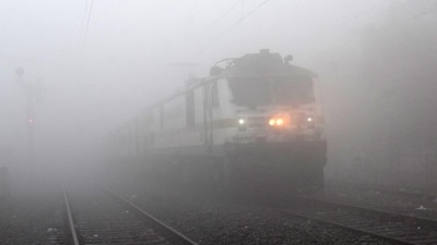 A train crossing in fog at the Patna Junction railway station on a cold winter morning, Bihar,India, Friday,29, 2023. (Photo by Santosh Kumar / Hindustan Times)