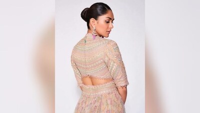 In terms of accessories, Mrunal kept her look minimal, opting for a pair of diamond statement earrings with a stunning pink emerald at the bottom, statement diamond rings adorning her fingers and a pair of silver high heels. (Instagram/@mrunalthakur) In terms of accessories, Mrunal kept her look minimal, opting for a pair of diamond statement earrings with a stunning pink emerald at the bottom, statement diamond rings adorning her fingers and a pair of silver high heels. (Instagram/@mrunalthakur)