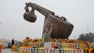 Prime Minister Narendra Modi, waves at a city square named after the legendary Indian singer Lata Mangeshkar before the inauguration of a new airport and a railway station in Ayodhya. Modi was in Ayodhya to inaugurate the redeveloped Ayodhya Dham train station and the newly built airport in the city. (AP)