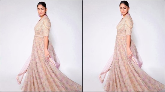 Mrunal's anarkali kurta set features a luxurious georgette and silk fabric, a deep v-neckline, elbow-length sleeves and intricate multi-coloured thread embroidery with crystal detailing at the yoke. The bottom of her kurta featured multicoloured floral prints and a beautiful flared hem. She paired it with a matching duppata and a stretch net churidar.(Instagram/@mrunalthakur)