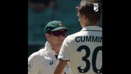 Steve Smith talking to Pat Cummins