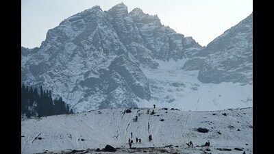Tourists enjoy ahead of the New Year, in Sonamarg on Sunday. (Waseem Andrabi /HT)