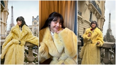The first set of clicks shows Lisa posing on her hotel's balcony with the backdrop of the Eiffel Tower and sitting inside the hotel room. She wore a bright yellow fur jacket for the photoshoot featuring broad-notch lapel collars, full-length sleeves, padded shoulders, and a matching belt embellished with metal plates. She styled the look with a white shirt dress, a messy half-tied hairdo, and a dewy no-makeup look. (Instagram) The first set of clicks shows Lisa posing on her hotel's balcony with the backdrop of the Eiffel Tower and sitting inside the hotel room. She wore a bright yellow fur jacket for the photoshoot featuring broad-notch lapel collars, full-length sleeves, padded shoulders, and a matching belt embellished with metal plates. She styled the look with a white shirt dress, a messy half-tied hairdo, and a dewy no-makeup look. (Instagram)