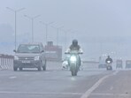 Commuters out on a cold and Foggy morning amid rising air pollution levels at Ghazipur area  in New Delhi on Saturday. 
