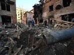 Local residents inspect damages outside an apartment building after the overnight Russian drones attack in Kharkiv, December 31, 2023. Local residents inspect damages outside an apartment building after the overnight Russian drones attack in Kharkiv, December 31, 2023.