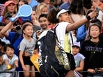 Japan's Naomi Osaka (R) takes a selfie with fans after victory during her women's singles match against Germany's Tamara Korpatsch at the Brisbane International tennis tournament in Brisbane on January 1, 2024