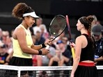 Japan's Naomi Osaka (L) bumps racquets with Germany's Tamara Korpatsch after victory during their women's singles match at the Brisbane International tennis tournament in Brisbane on January 1