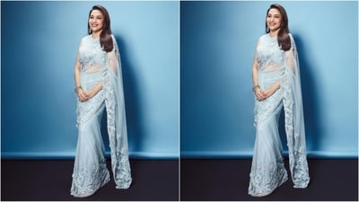 Madhuri's mesmerising saree comes in an enchanting sky-blue colour and is made of net fabric with intricate floral embroidery and crystal embellishments adorning the border. She teamed it with a matching sleeveless blouse and draped it elegantly around her, letting the saree fall beautifully from her shoulders. (Instagram/@madhuridixitnene) Madhuri's mesmerising saree comes in an enchanting sky-blue colour and is made of net fabric with intricate floral embroidery and crystal embellishments adorning the border. She teamed it with a matching sleeveless blouse and draped it elegantly around her, letting the saree fall beautifully from her shoulders. (Instagram/@madhuridixitnene)