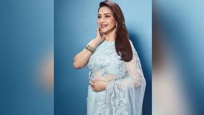 Madhuri accessorised her look with a pair of statement earrings featuring green emeralds and matching stacked bangles adorning her wrist. She left her straightened hair open in the side parting, which cascaded beautifully down her shoulders. (Instagram/@madhuridixitnene) Madhuri accessorised her look with a pair of statement earrings featuring green emeralds and matching stacked bangles adorning her wrist. She left her straightened hair open in the side parting, which cascaded beautifully down her shoulders. (Instagram/@madhuridixitnene)