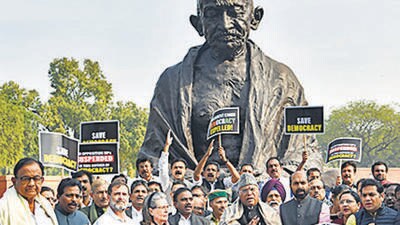 Opposition MPs hold a protest against the suspensions in front of Gandhi statue on December 20. (ANI) Opposition MPs hold a protest against the suspensions in front of Gandhi statue on December 20. (ANI)