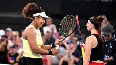 Japan's Naomi Osaka (L) bumps racquets with Germany's Tamara Korpatsch after victory during their women's singles match at the Brisbane International tennis tournament in Brisbane on January 1 (AFP)