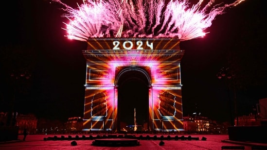 New Year 2024: Fireworks underway next to the Arc de Triomphe at the Avenue des Champs-Elysees during New Year celebrations in Paris.(AFP)