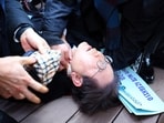 South Korean opposition party leader Lee Jae-myung is attended to after being attacked in Busan on January 2. South Korean opposition party leader Lee Jae-myung is attended to after being attacked in Busan on January 2.