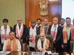 Union Home Minister Amit Shah and Assam Chief Minister Himanta Biswa Sarma with members of United Liberation Front of Asom (ULFA) during signing of a peace accord between ULFA and the central and Assam governments, in New Delhi, Friday. (PTI)